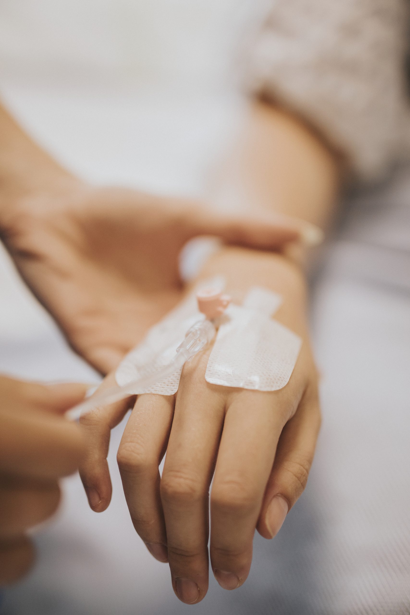 Nurse applying an IV drip to a patient